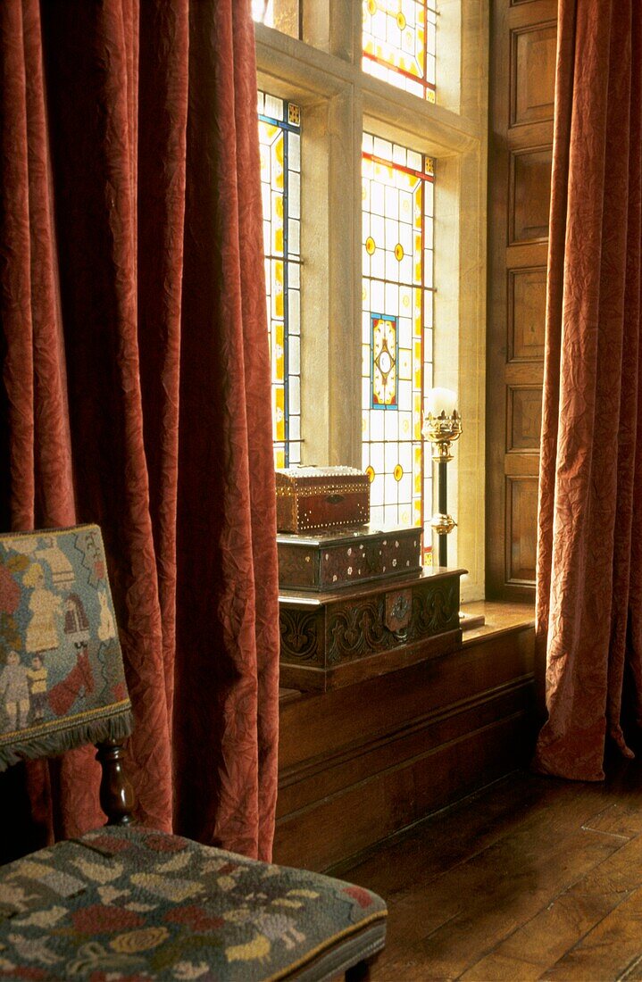 Stone framed picture stained glass window setting in country hall