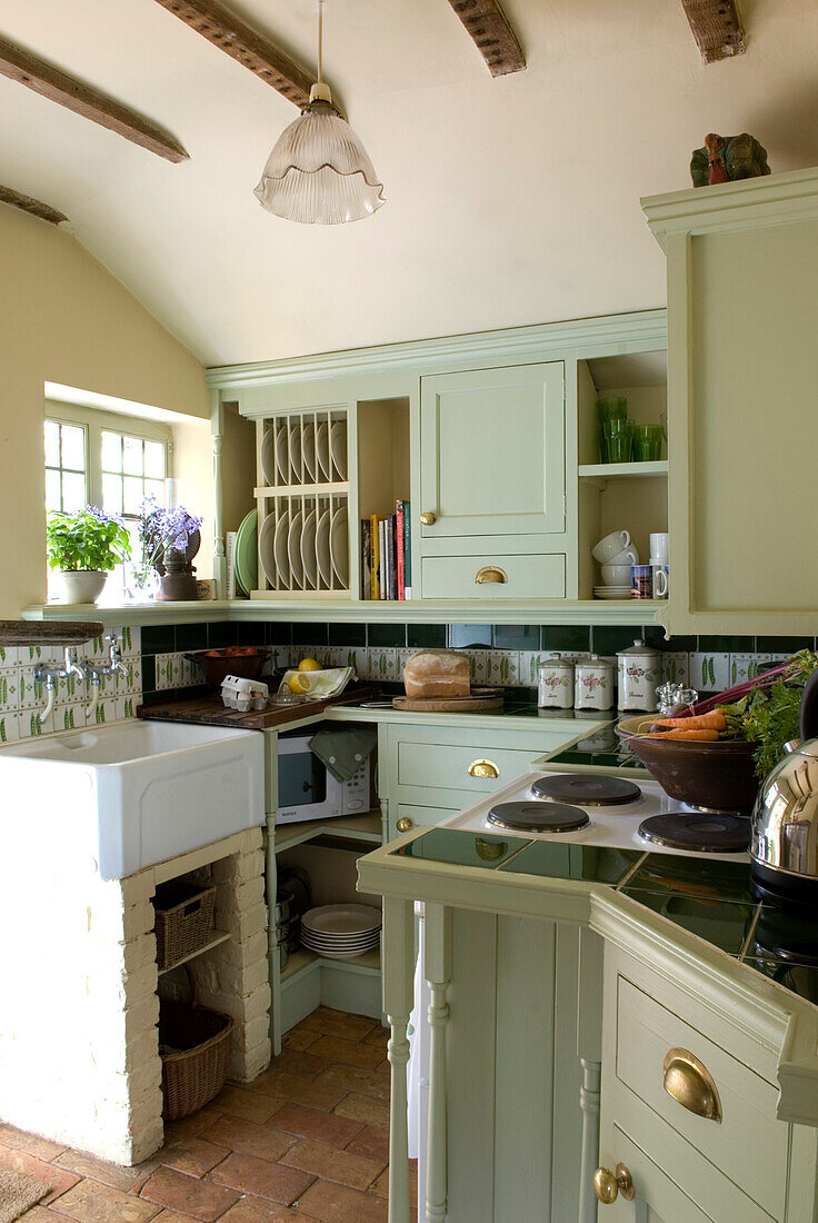Country kitchen set below eaves in pastel green