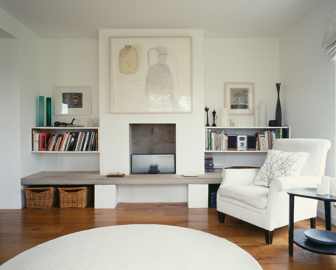 Living room with concrete fireplace slab forming bottom shelf of alcove 