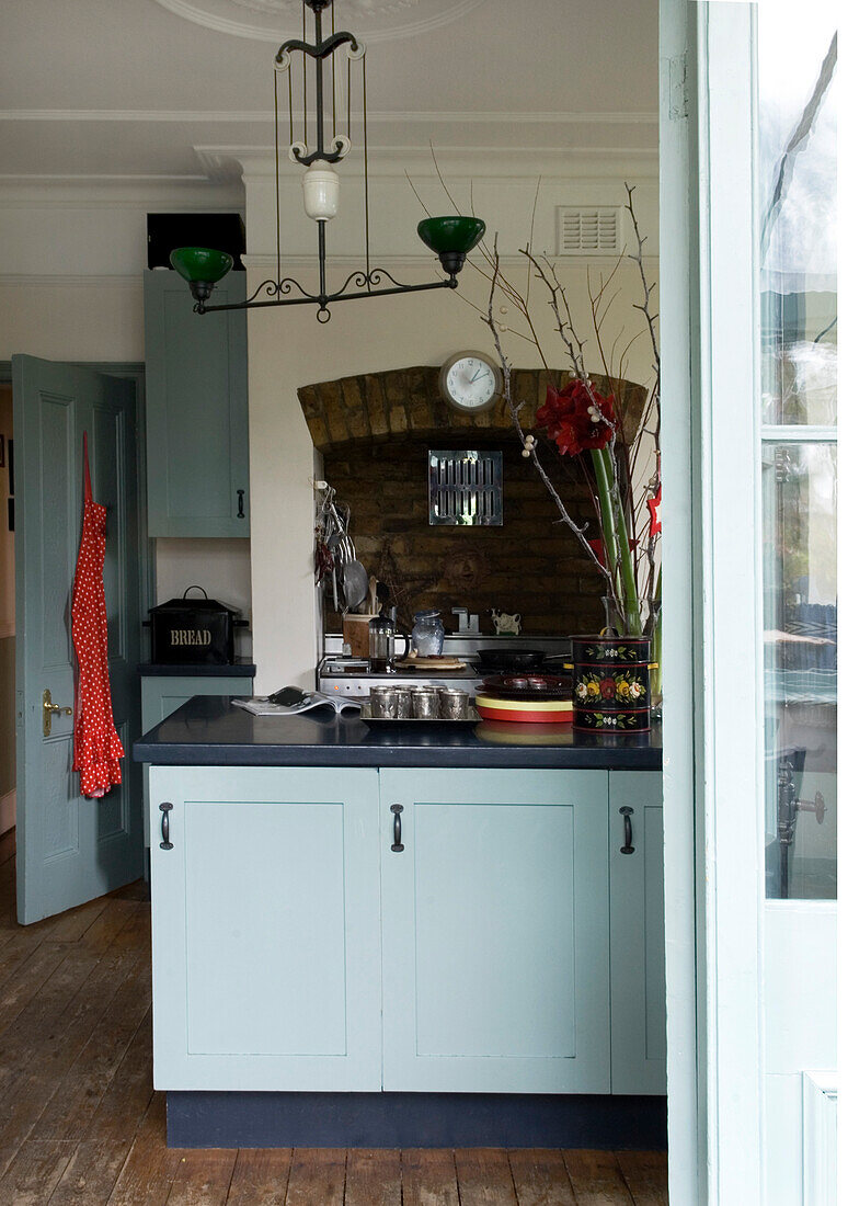 Recessed hob alcove in kitchen with pastel blue cupboard doors
