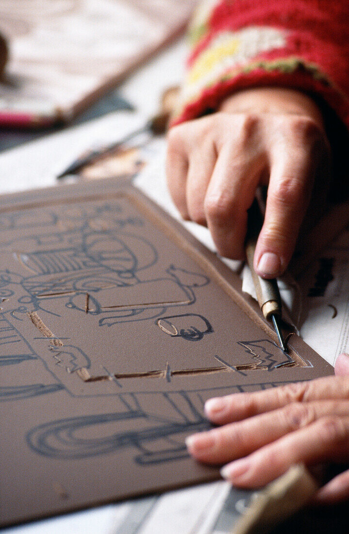 Man working with leatherwork design