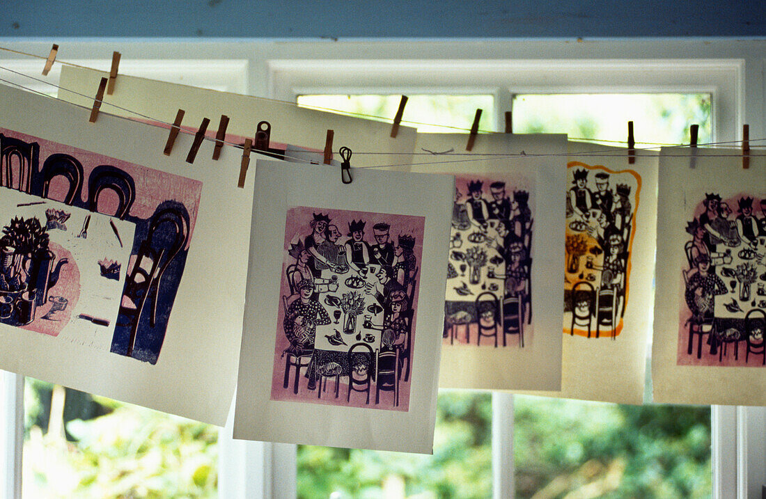 Printed artwork hangs in summerhouse window