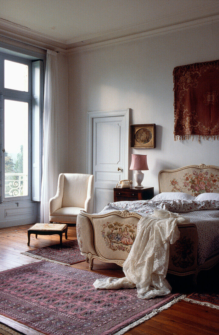 Embroidered head and footboards in French apartment bedroom