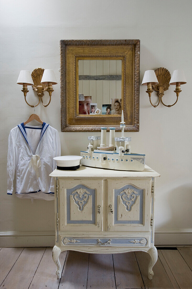 Mirror and cabinet with model ship