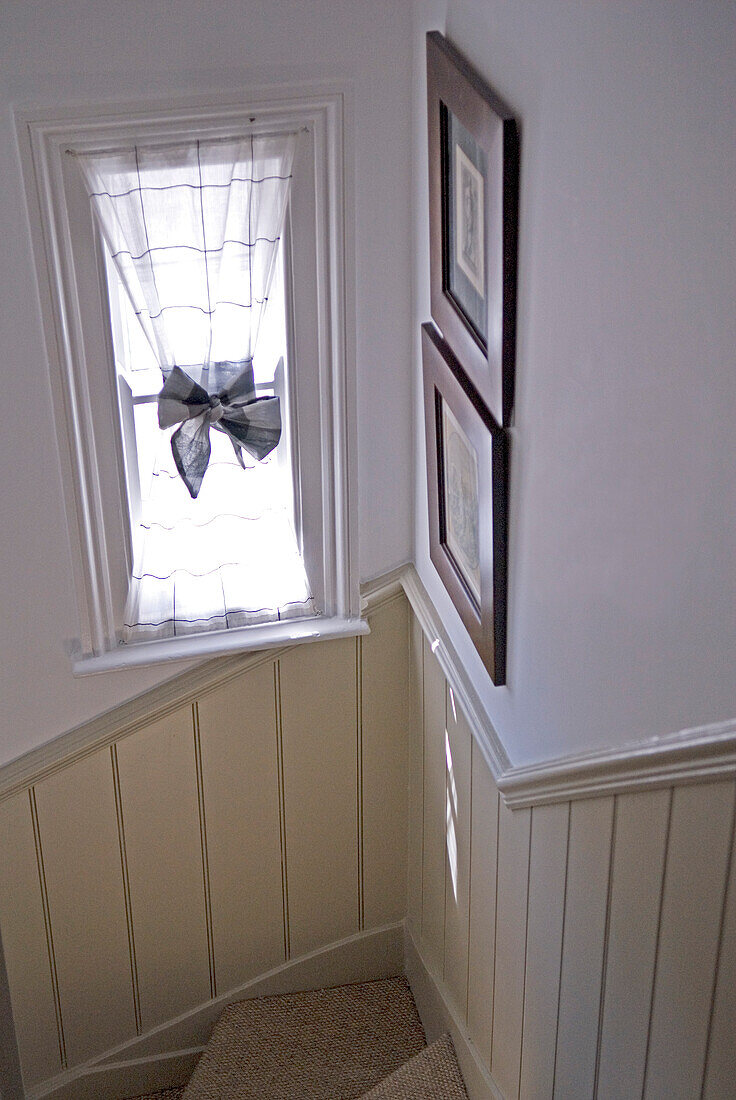 Reeded panelling to dado height with voile at window with bow tied 