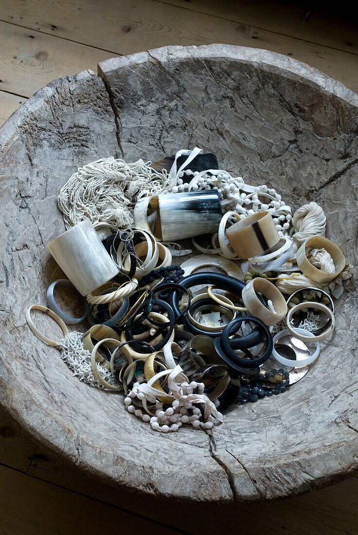 Wooden bowl full of jewellery