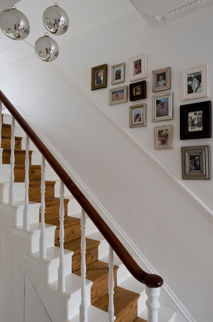 Picture frames over staircase with mirror balls