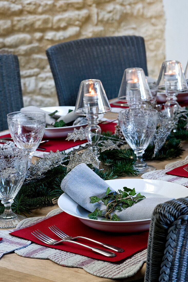 Ivy decoration on napkin at place settings for Christmas dinner in Wiltshire farmhouse