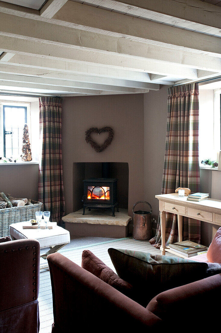 Wood burning stove in corner of room under heart shape wreath Wiltshire