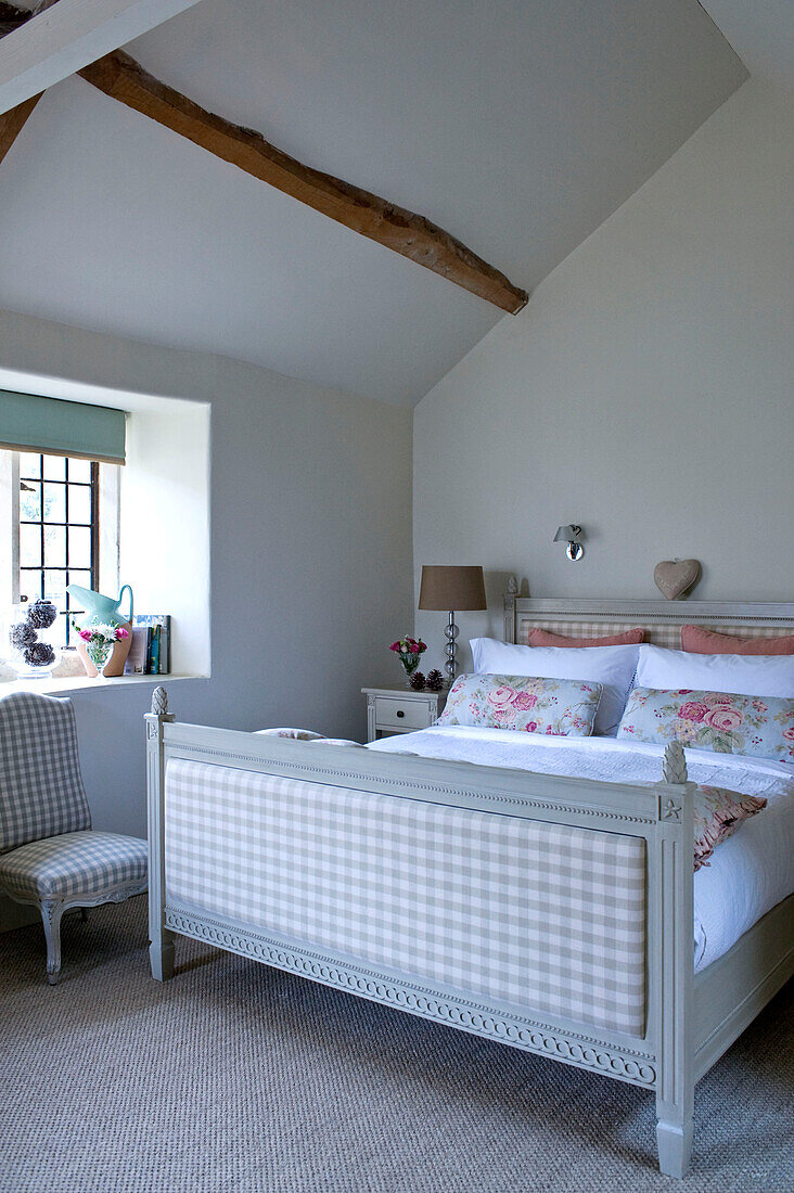 Gingham checked footboard on bed in Wiltshire cottage