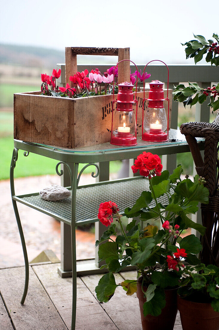Lit lanterns and a crate of plants on a Hereford veranda