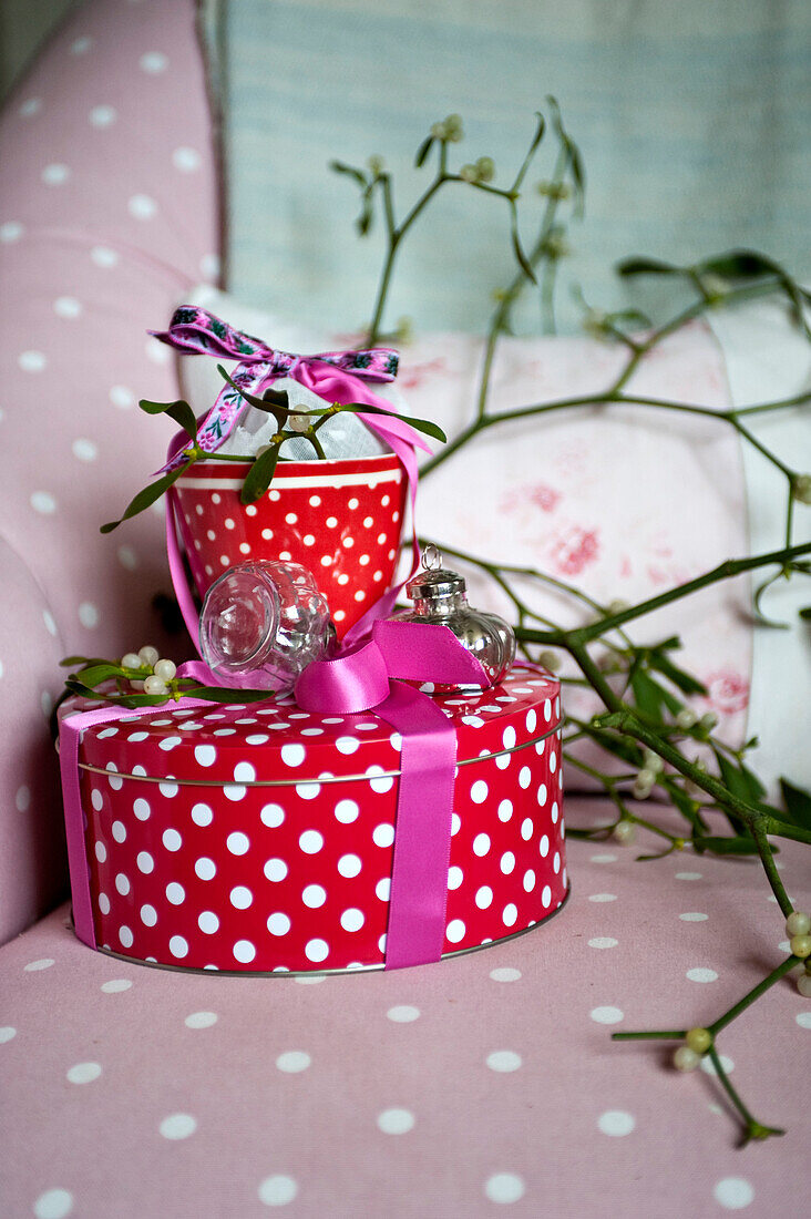 Red spotted gift wrapped homeware with mistletoe