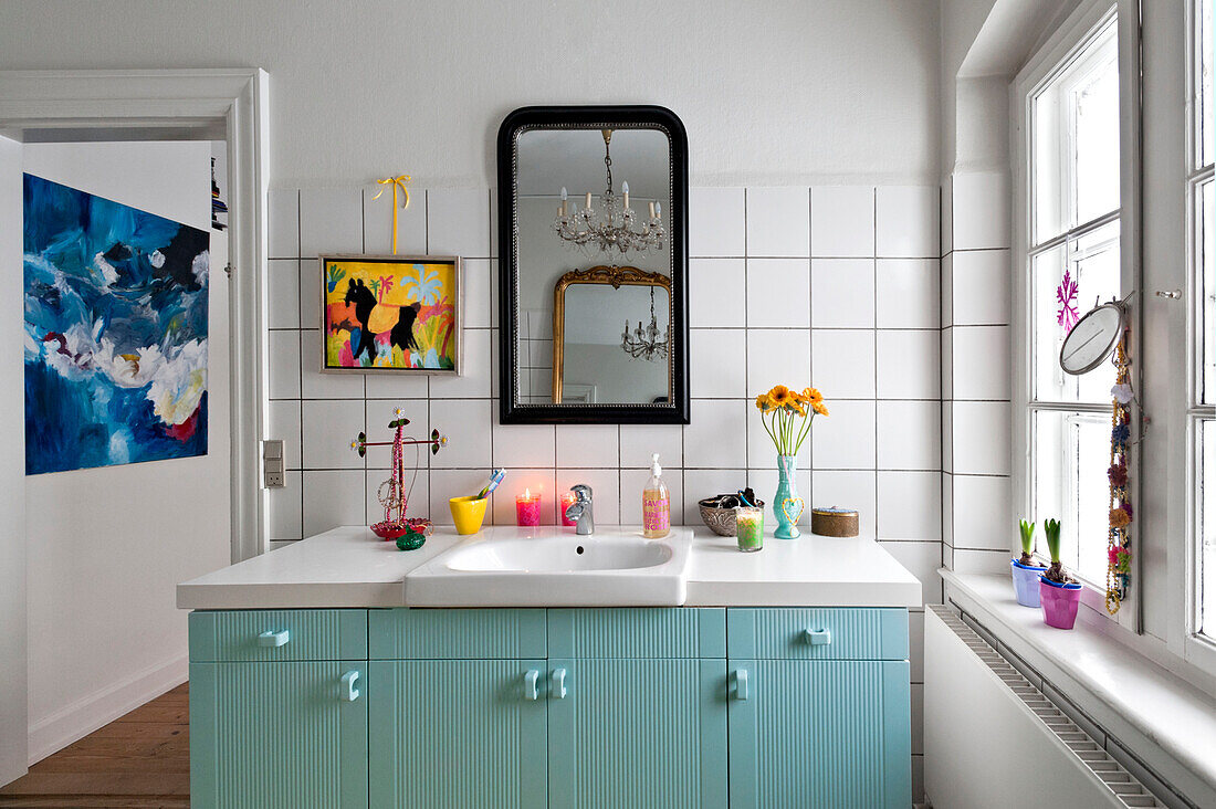 Modern art ad pastel blue bathroom storage in modern Odense family home Denmark