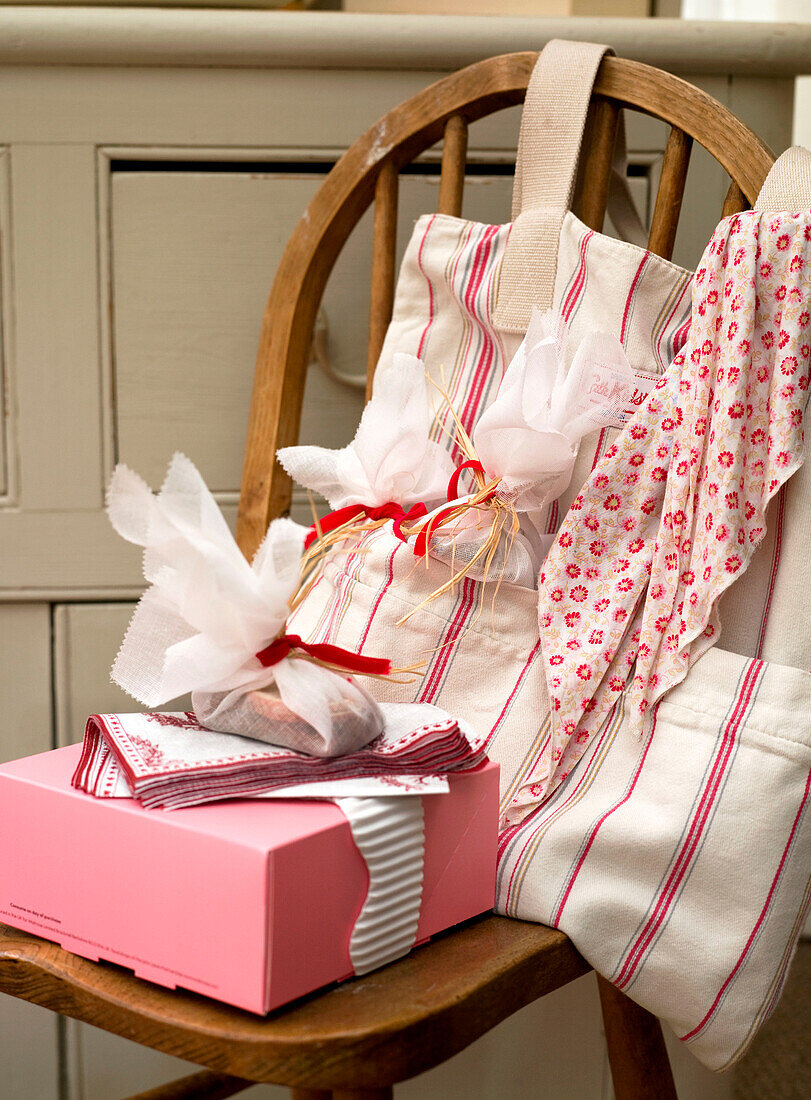 Cake box and storage pouch on wooden kitchen chair
