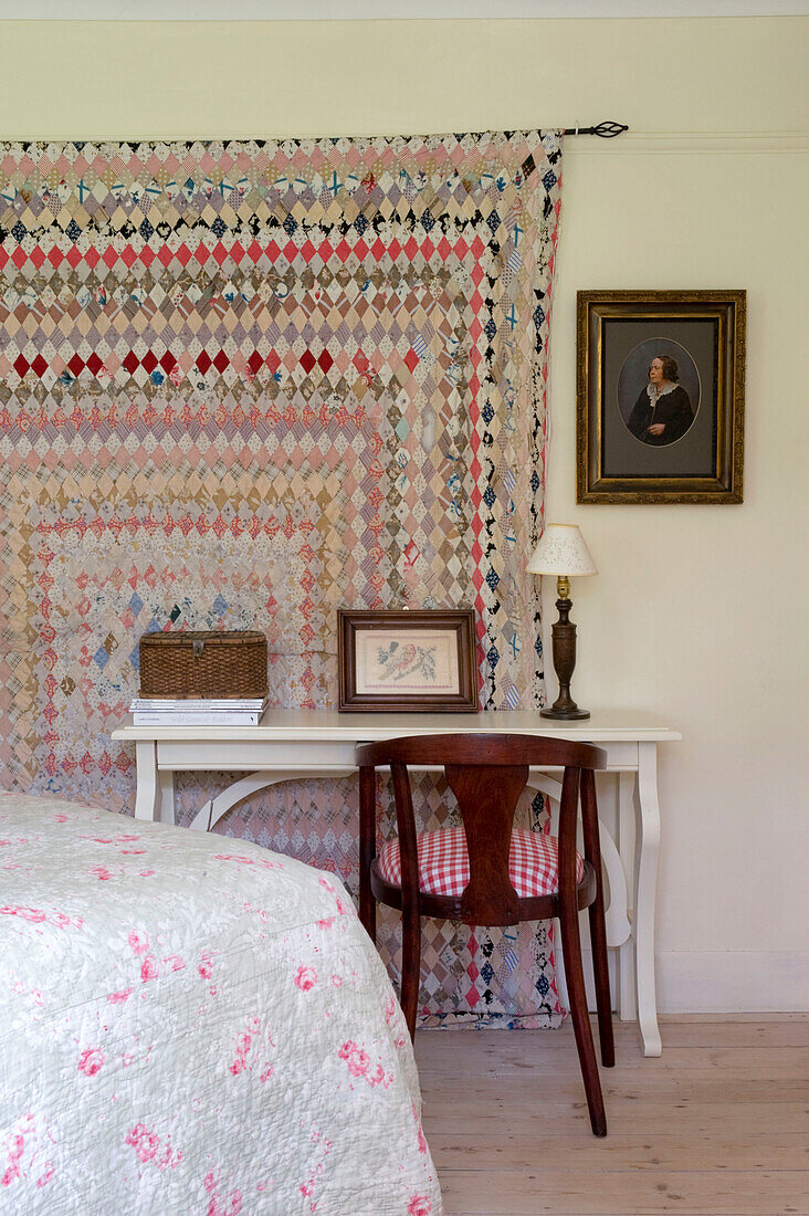 Patchwork quilt hangs on wall of Devon bedroom