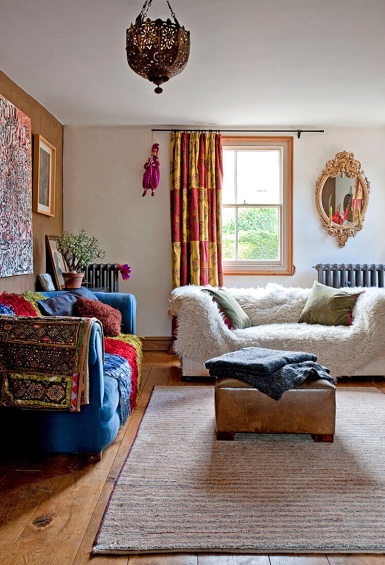 Colourful fabrics in eclectic living room of UK home