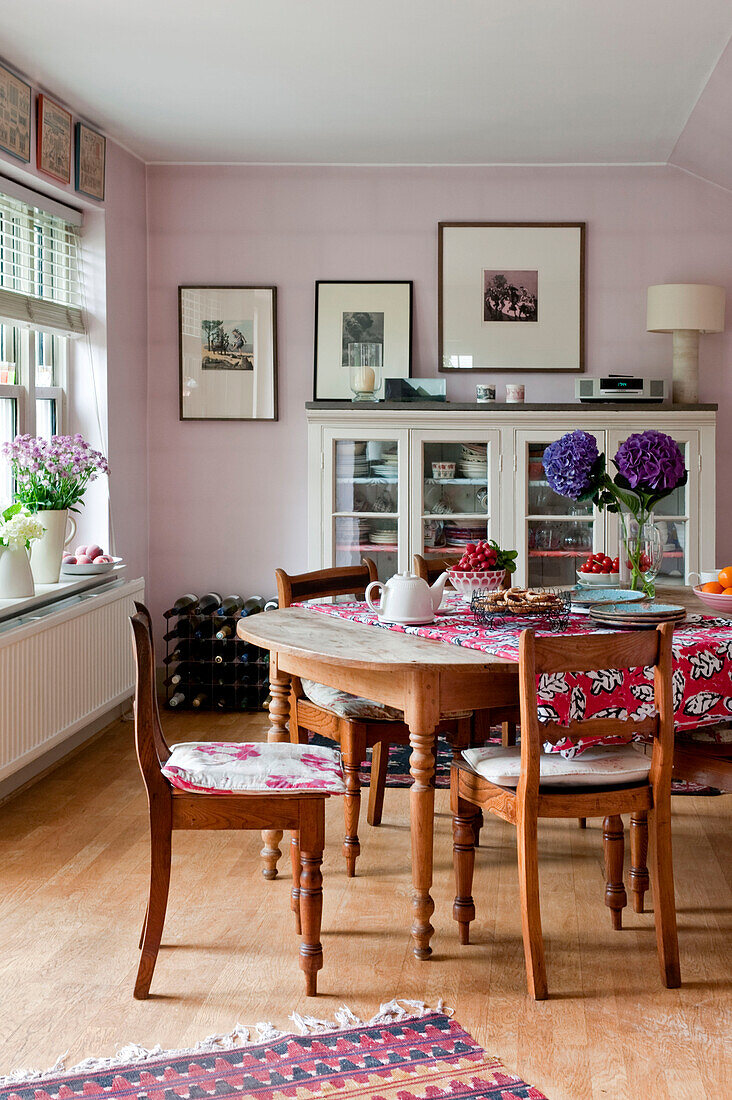 Esstisch und Stühle aus Holz mit Glasvitrine in einem Londoner Haus UK