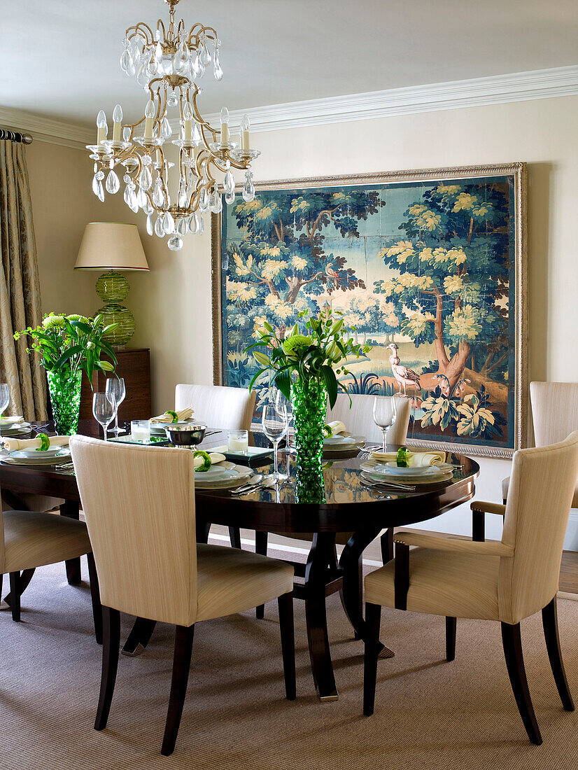 Dining table and chairs with artwork in West London townhouse England UK