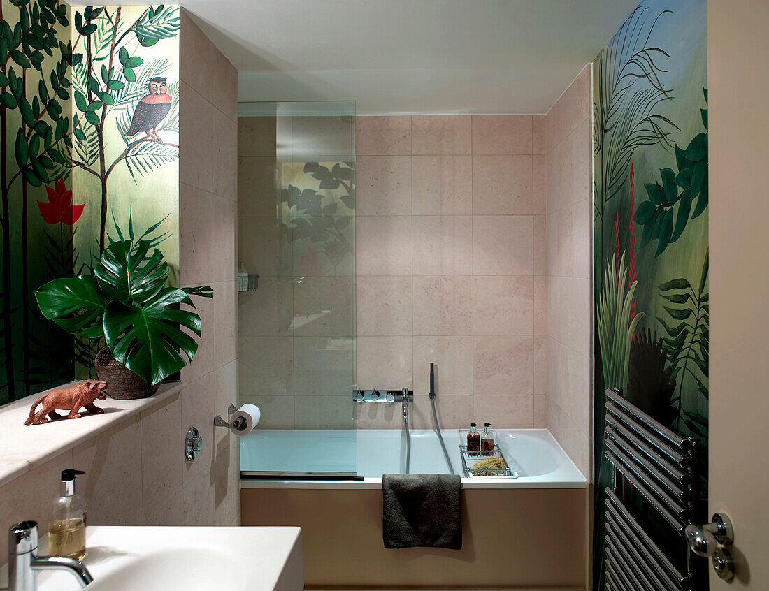 Bathroom painted with forest scenes in London apartment England UK