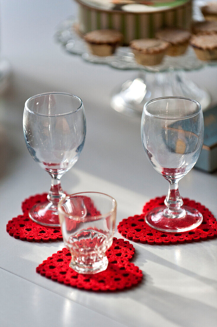Wineglasses on heart shaped coasters in Forest Row family home, Sussex, England, UK