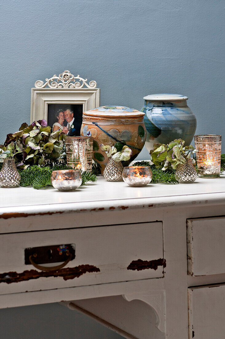 Homeware and tealights on distressed dressing table in Forest Row family home, Sussex, England, UK