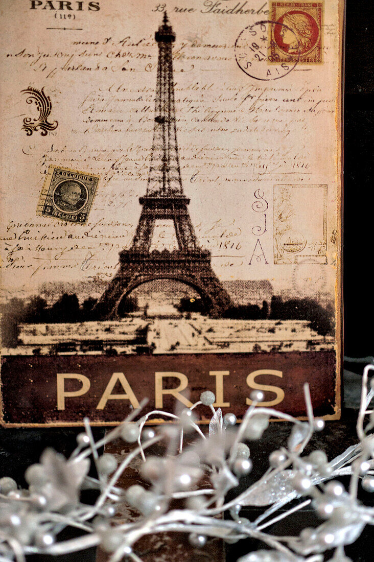 Vintage Eiffel tower souvenir artwork with silver Christmas decorations in Paris apartment, France