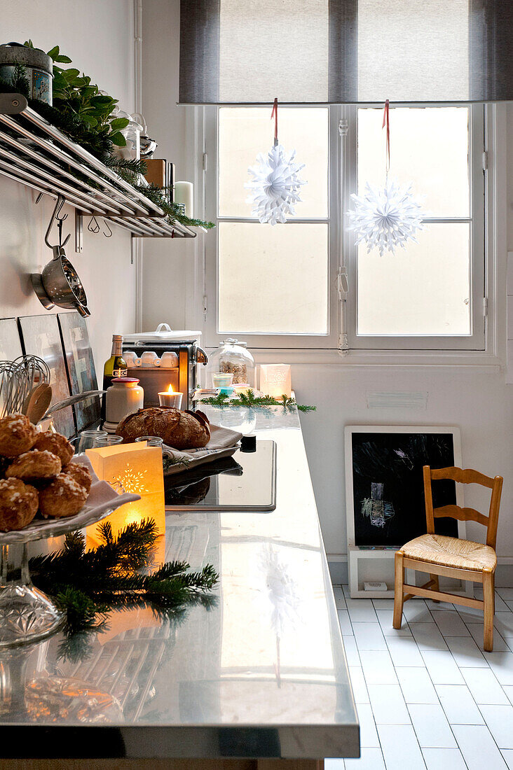 Lit candles on kitchen counter in Paris apartment kitchen at Christmas, France