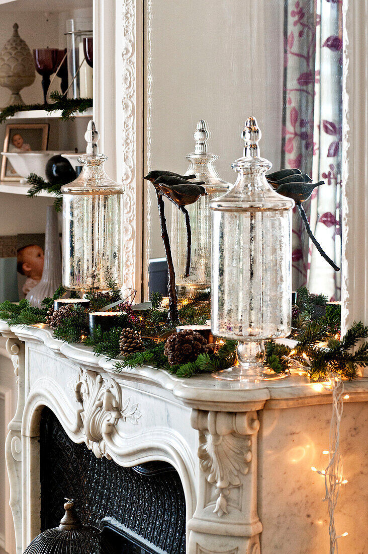 Christmas decorations on marble fireplace in Paris apartment, France