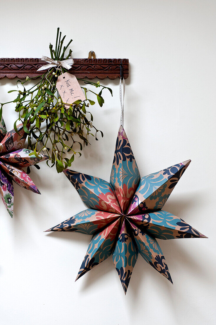 Star shaped Christmas decoration and mistletoe in Walberton home, West Sussex, England, UK