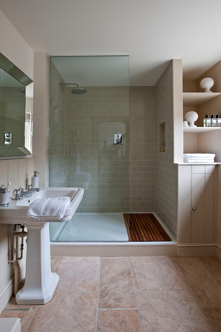 Pedestal basin with glass shower screen in wet room of Buckinghamshire home, England, UK