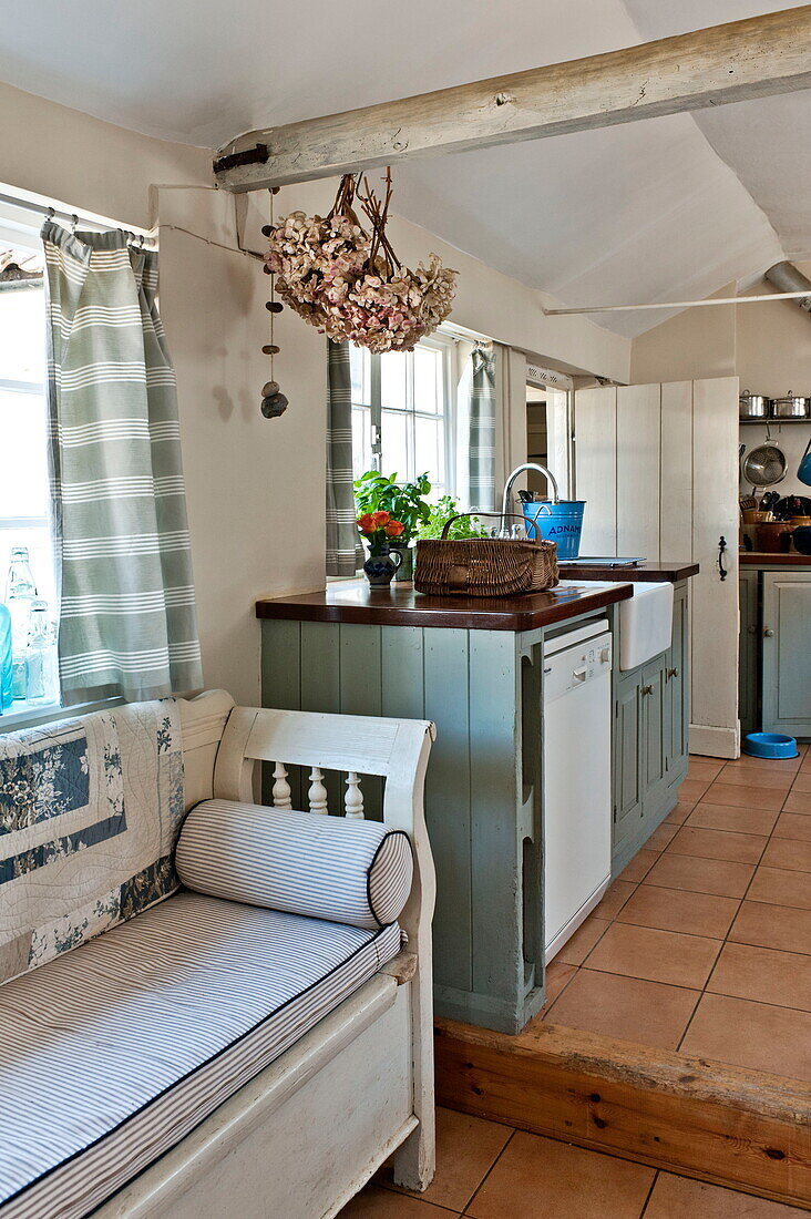 Sitzbank in geteilter Küche eines Bauernhauses in Suffolk, England, UK