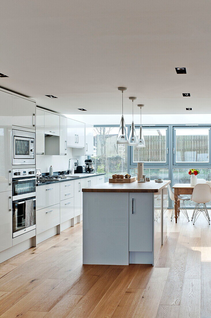 Kitchen island in white fitted kitchen of Wadebridge home, Cornwall, England, UK