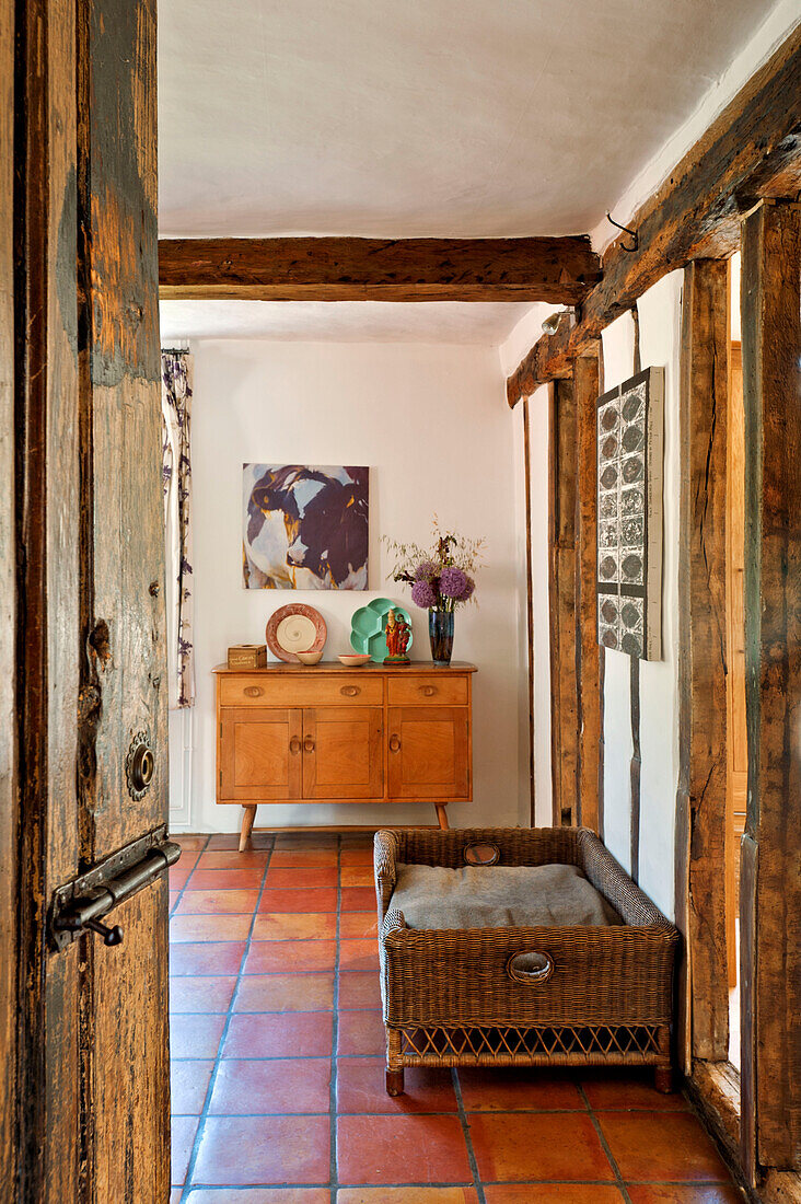 view through doorway to tiled living room with dog basket in Hertfordshire home, England, UK
