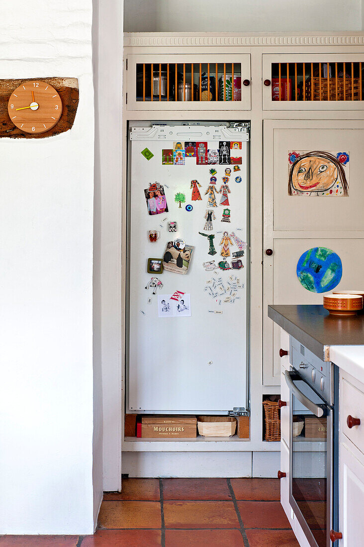 Childs drawing and reminders on fridge in Hertfordshire home, England, UK