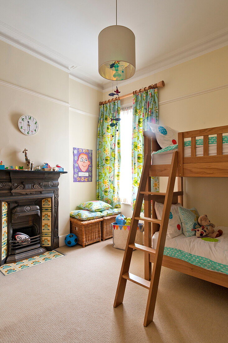 Wooden bunkbed with ladder in child's room of Middlesex family home, London, England, UK