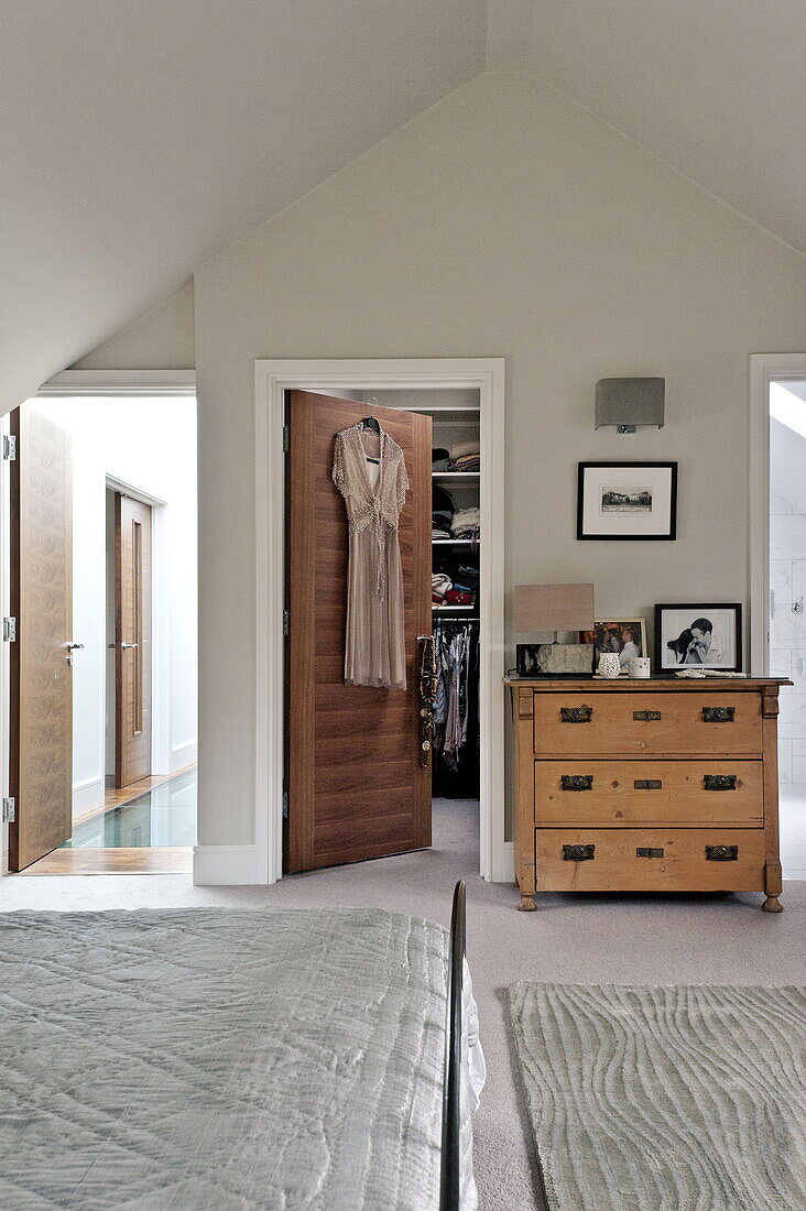 Master bedroom with dressing room in roof space of London home, England, UK