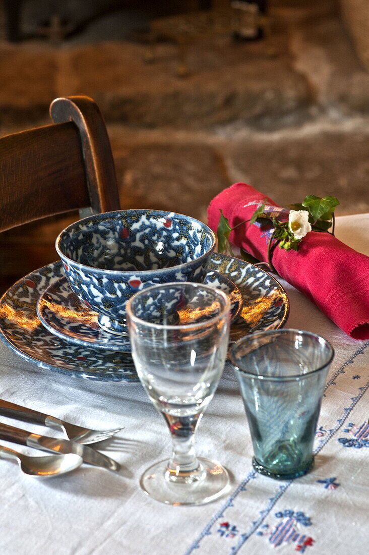 Wine glass at place setting in farmhouse dining room, Cornwall, England, UK