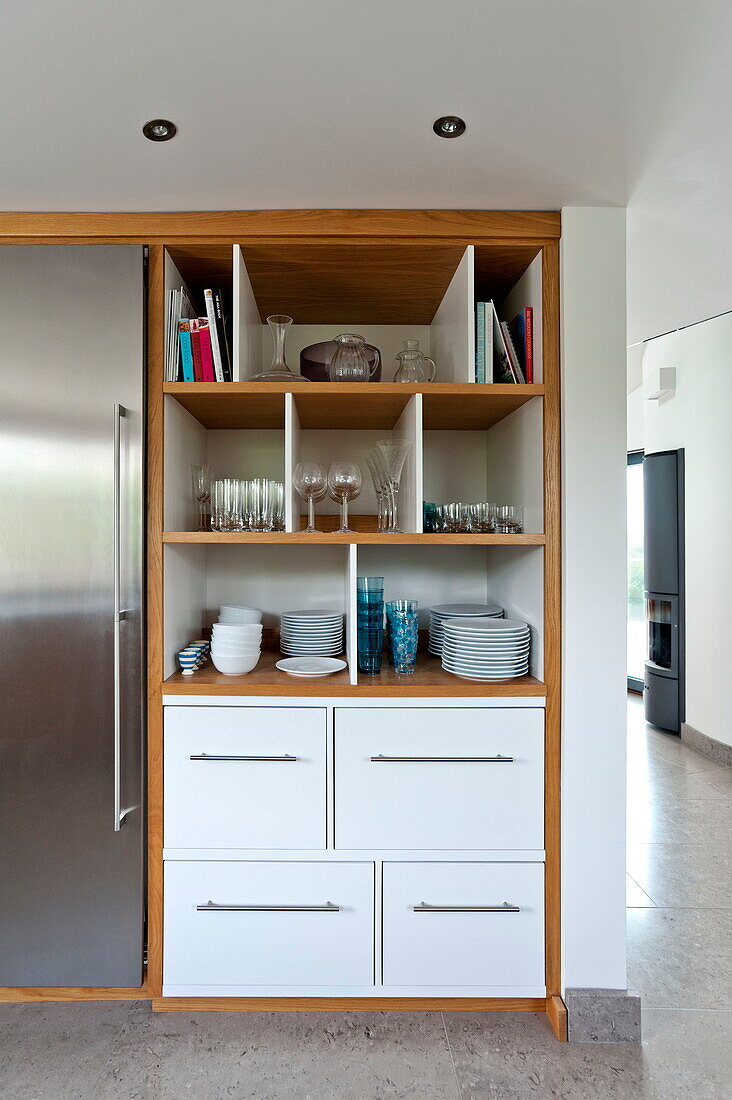 Glassware and crockery storage in contemporary kitchen, Cornwall, England, UK