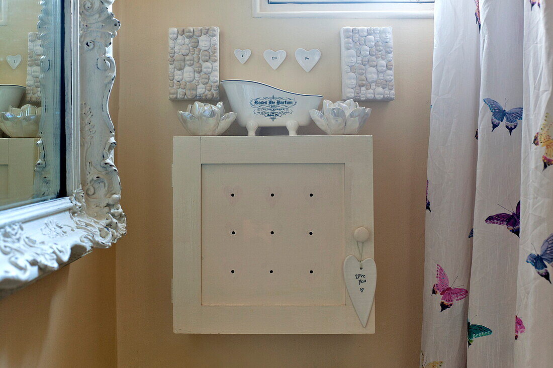 Bathroom cabinet with heart-shaped ornaments in London home, England, UK