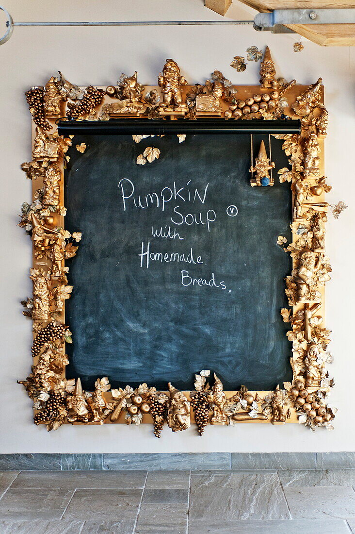 Handwriting on large blackboard with gold fruit surround in Blagdon home, Somerset, England, UK
