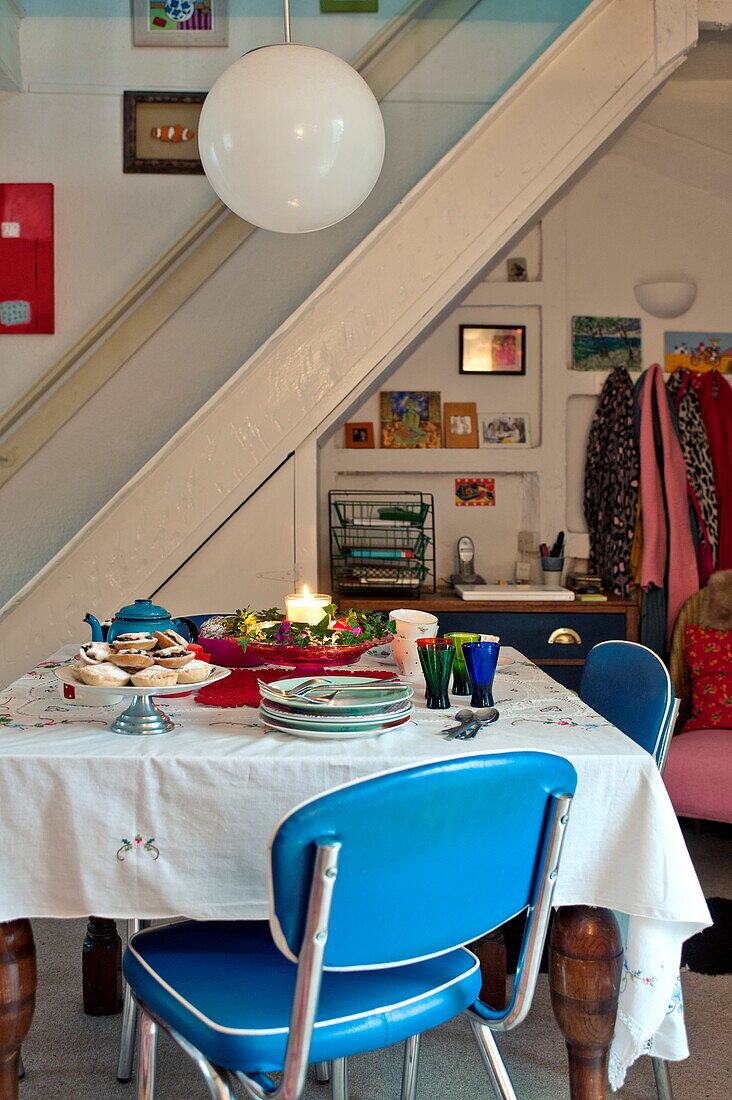 Esstisch mit Mince Pies und blauen Vintage-Stühlen in einem Cottage in Penzance, Cornwall, Großbritannien