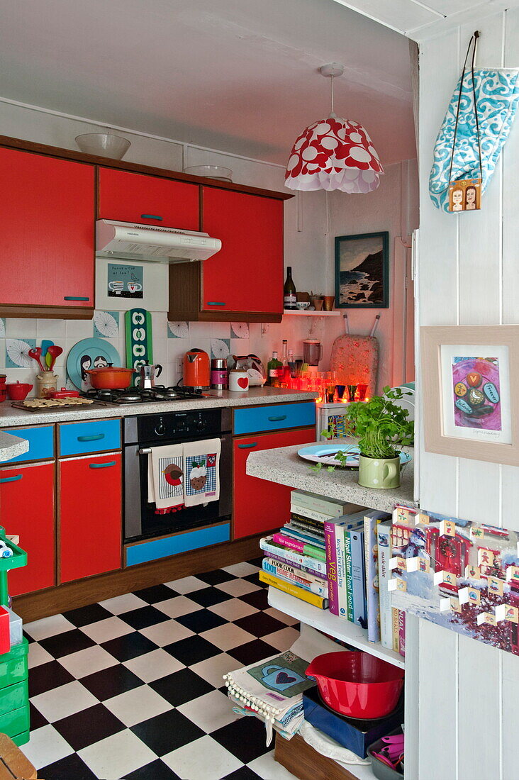 Red and blue 1950's style kitchen in Penzance cottage Cornwall England UK