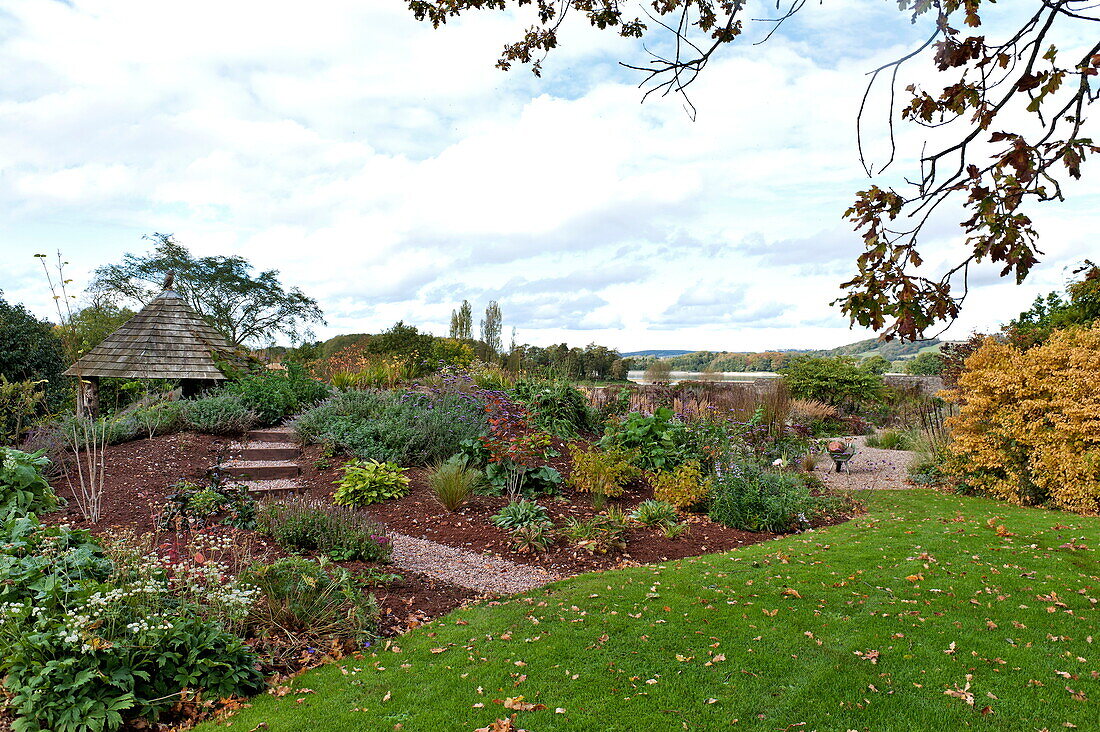 Garden structure and flowerbed in rural Blagdon, Somerset, England, UK