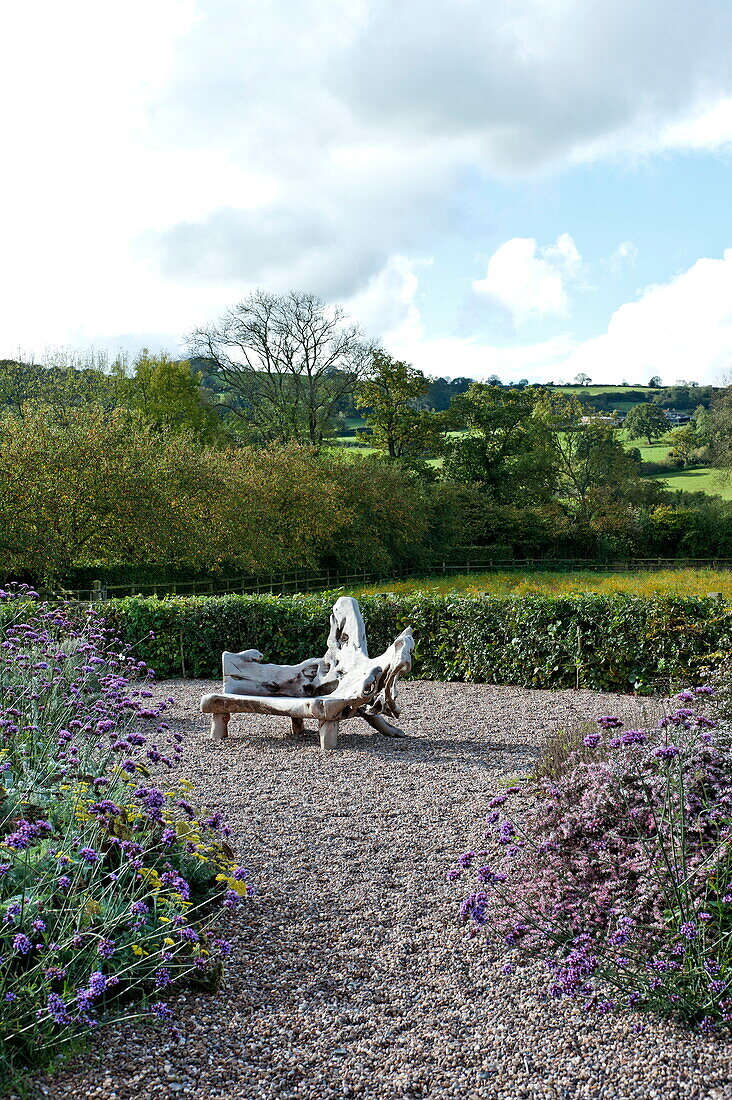 Garden seating on gravel in rural garden, Blagdon, Somerset, England, UK