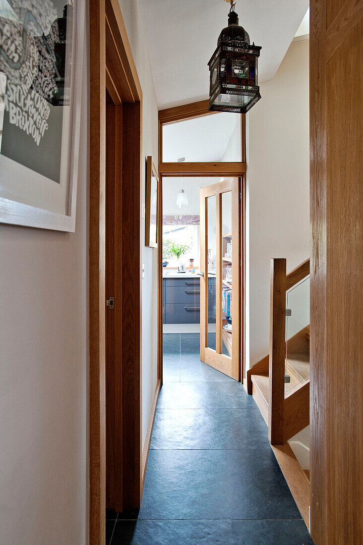 View through wooden front door from hallway of modern family home, Cornwall, UK