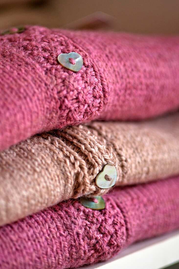 Folded pink cardigans with heart-shaped buttons Cornwall UK