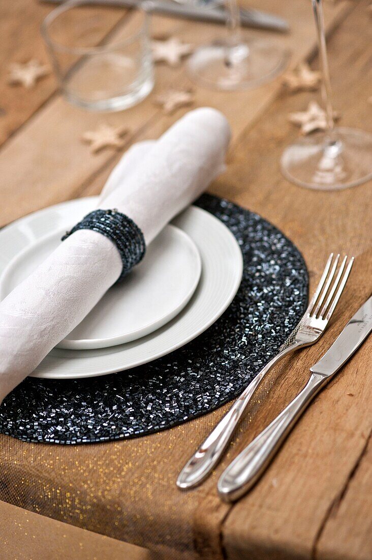 Sparkly napkin ring and place mat at table setting in Wadebridge family home, North Cornwall, UK