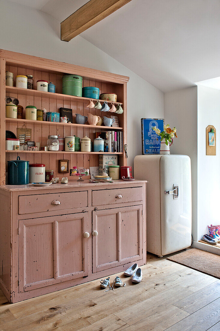 Kitchenware on painted dresser in Cambridge cottage England UK