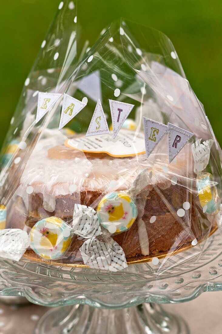 Easter cake on glass cake stand in Sussex garden UK