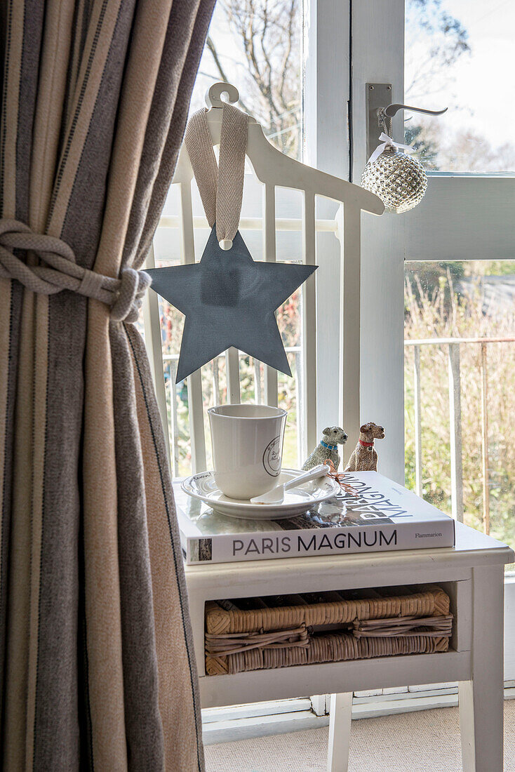 Star and a bauble with homeware on side table at back door in Penzance home Cornwall UK